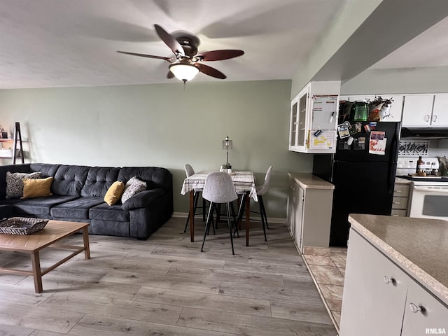 living room featuring ceiling fan and light wood-type flooring