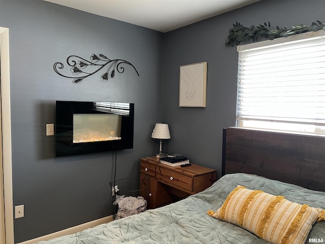 bedroom featuring a fireplace