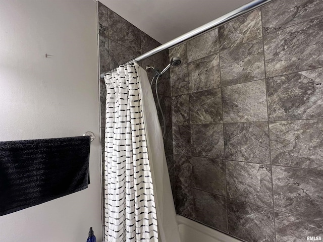 bathroom with shower / bath combo with shower curtain