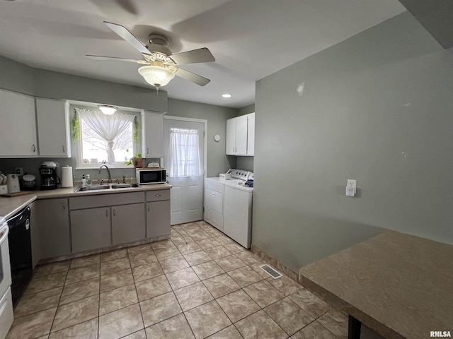 kitchen with sink, ceiling fan, white cabinetry, light tile patterned flooring, and separate washer and dryer