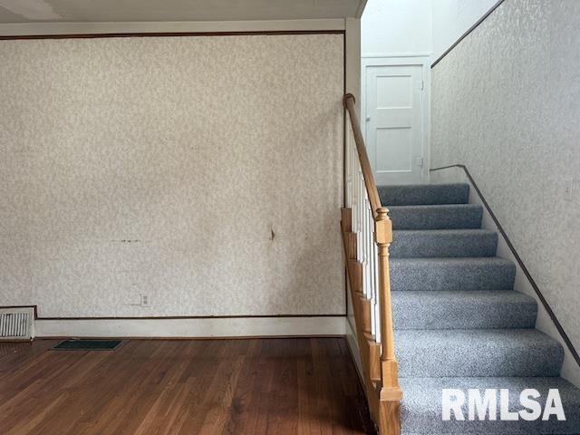 stairs with hardwood / wood-style floors