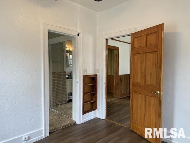 spare room featuring dark hardwood / wood-style flooring and ornamental molding