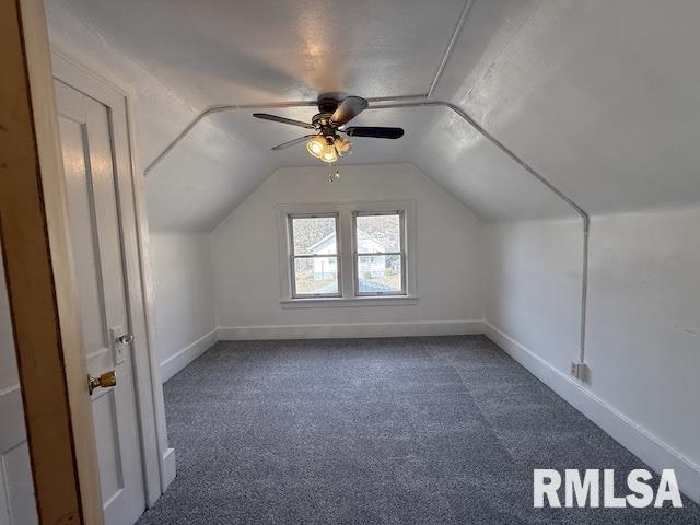 bonus room featuring ceiling fan, lofted ceiling, and carpet flooring