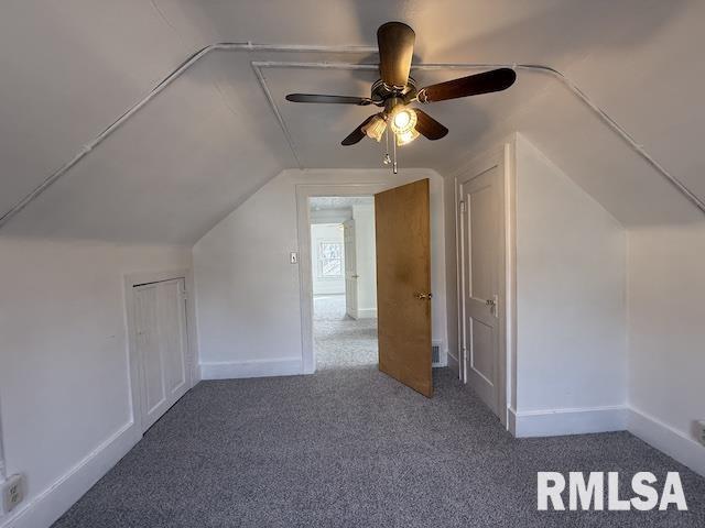 bonus room with vaulted ceiling and carpet