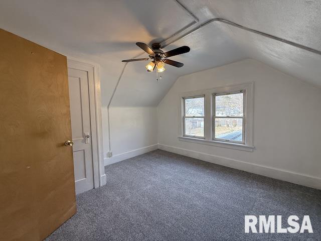 bonus room featuring lofted ceiling, a textured ceiling, carpet floors, and ceiling fan