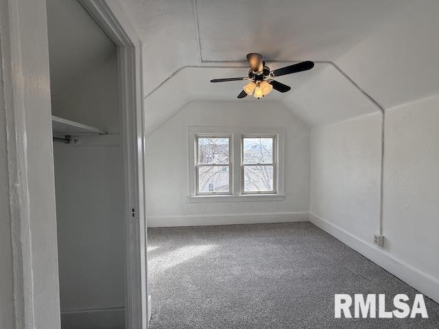 additional living space with ceiling fan, carpet flooring, and vaulted ceiling