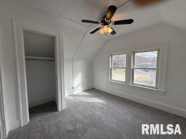 additional living space with vaulted ceiling and carpet