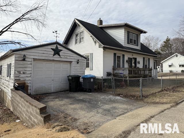 view of front facade featuring an outbuilding, a garage, and a porch