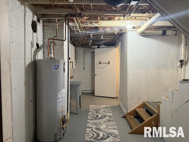 basement featuring water heater and sink