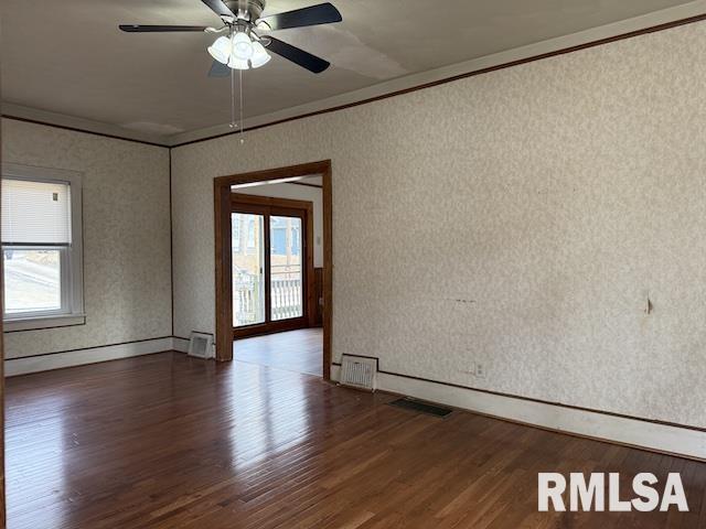 unfurnished room with ceiling fan, a healthy amount of sunlight, and dark hardwood / wood-style flooring