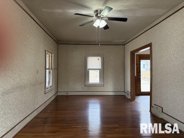 unfurnished room with dark wood-type flooring and ceiling fan