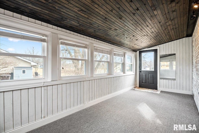 unfurnished sunroom featuring lofted ceiling, a healthy amount of sunlight, and wood ceiling