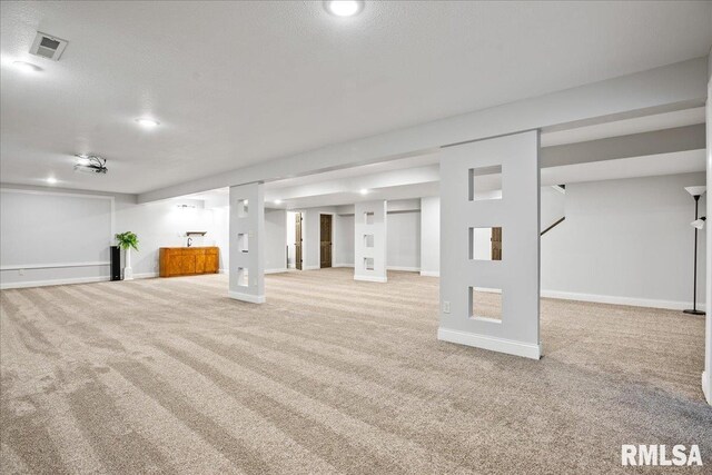 basement with carpet and a textured ceiling