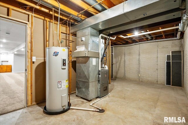 basement with brick wall, electric water heater, and heating unit