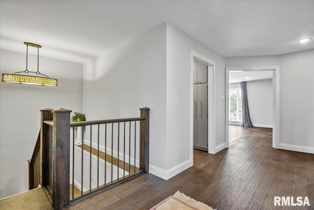 hallway with dark hardwood / wood-style floors