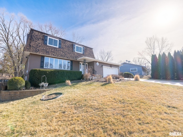 view of front of property featuring a garage and a front yard