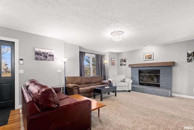 living room with a fireplace and a textured ceiling