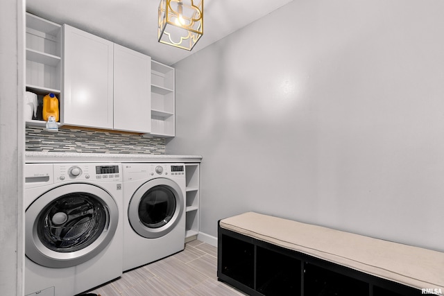 laundry room with cabinets and washing machine and clothes dryer