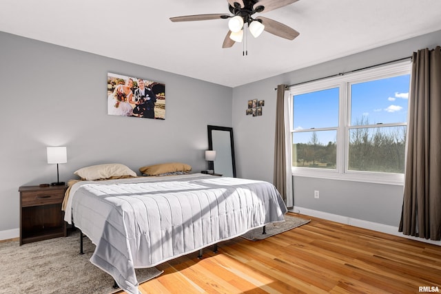 bedroom with wood-type flooring and ceiling fan