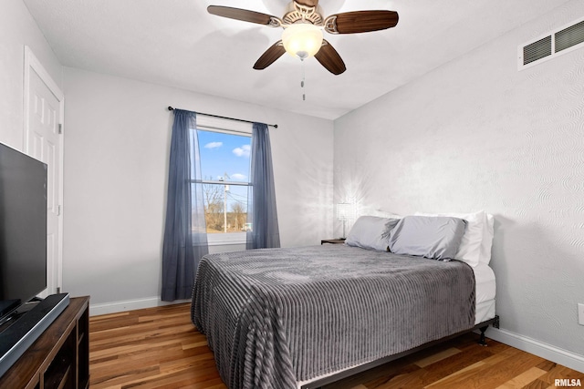 bedroom with ceiling fan and wood-type flooring