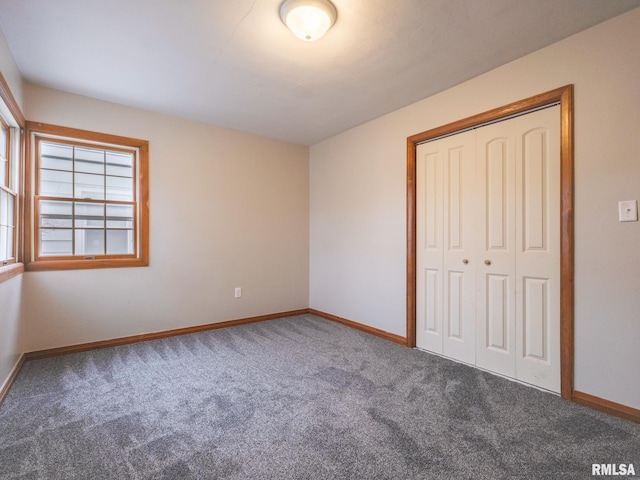 unfurnished bedroom with carpet floors and a closet