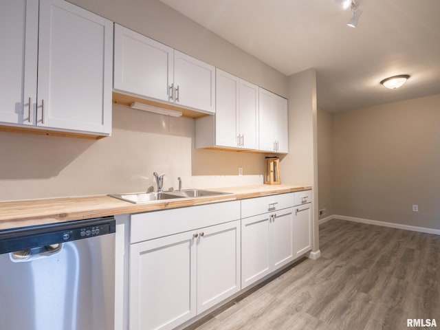 kitchen featuring light hardwood / wood-style flooring, sink, wooden counters, white cabinetry, and dishwasher