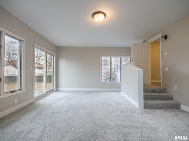 carpeted empty room with a healthy amount of sunlight