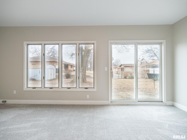 carpeted spare room with a healthy amount of sunlight