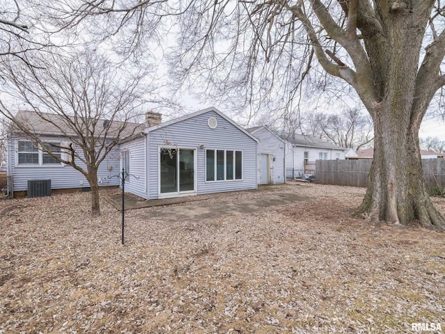 rear view of property with cooling unit