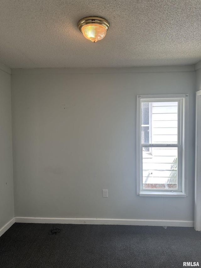 1822 N Sheridan Rd, Peoria, IL 61604 - spare room with dark colored carpet, a textured ceiling, and baseboards