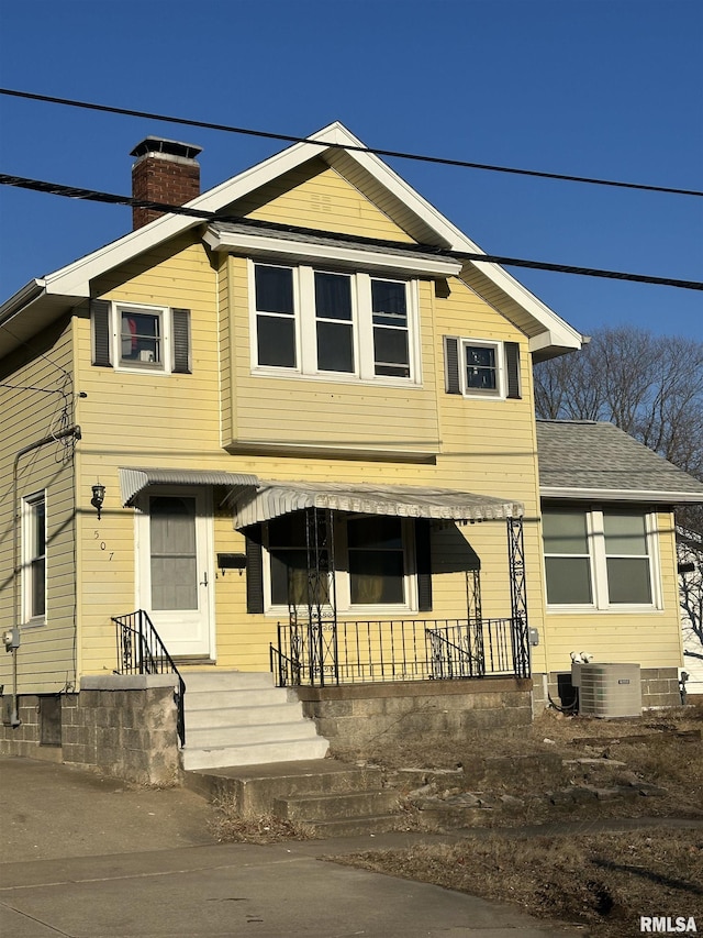 view of front facade with central AC unit and covered porch