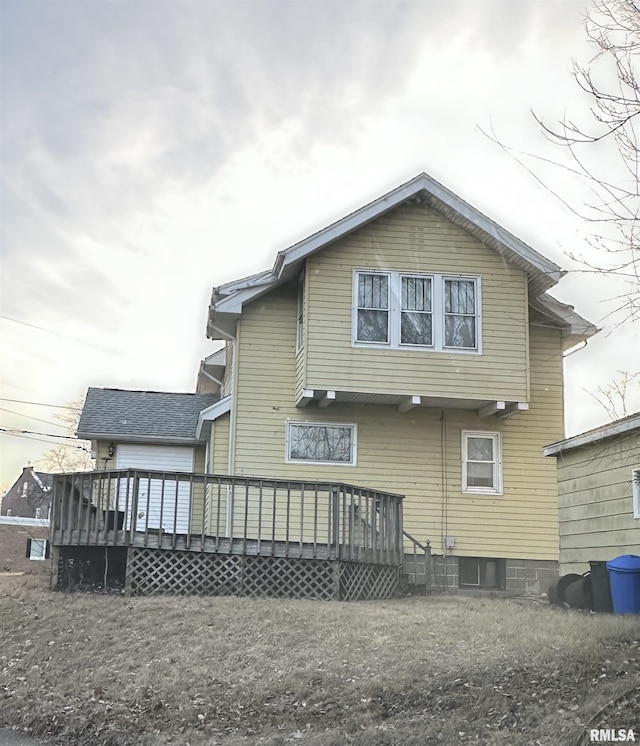 rear view of property with a wooden deck