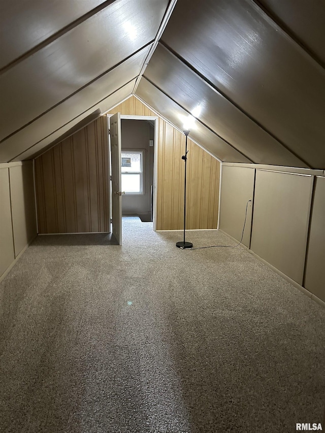 bonus room with lofted ceiling and carpet floors