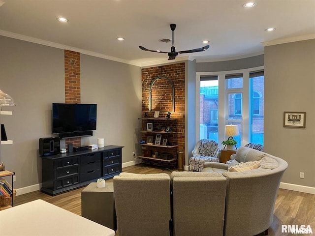 living room featuring crown molding, ceiling fan, and light wood-type flooring