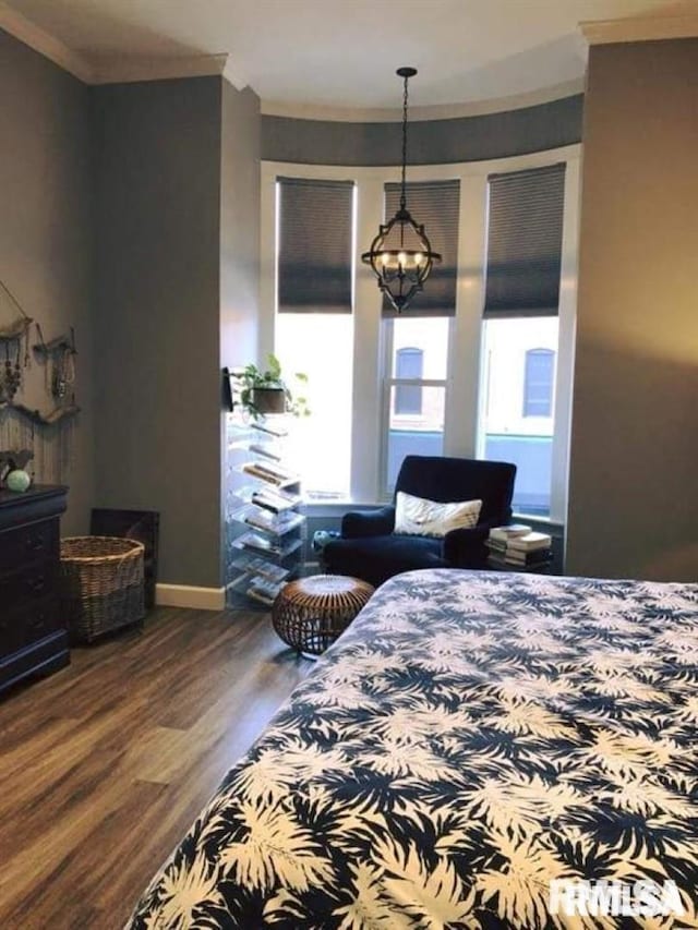 bedroom with crown molding, hardwood / wood-style floors, and a notable chandelier