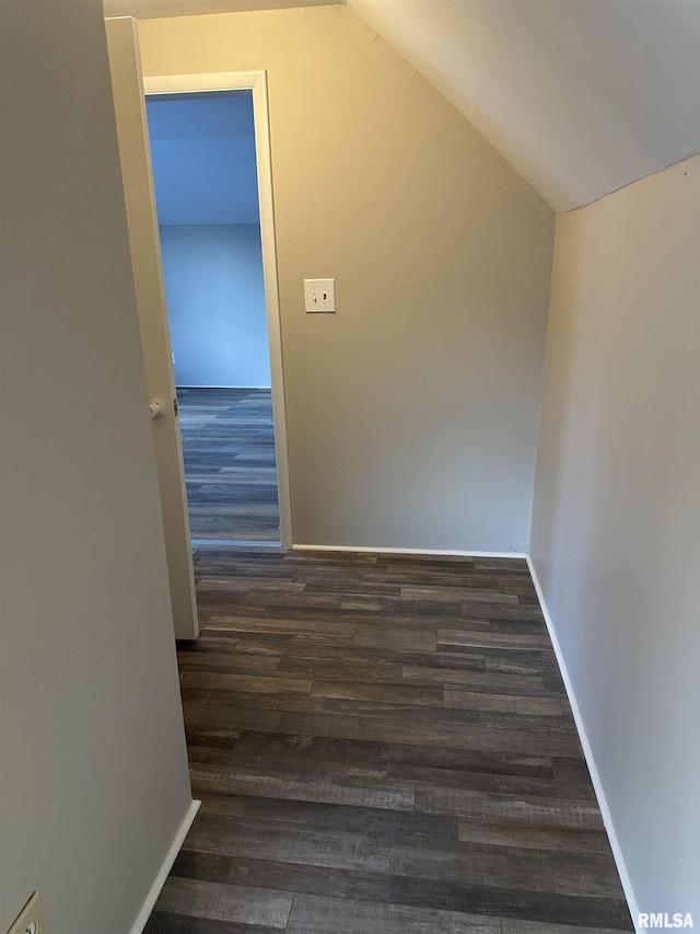 additional living space featuring dark hardwood / wood-style floors and vaulted ceiling