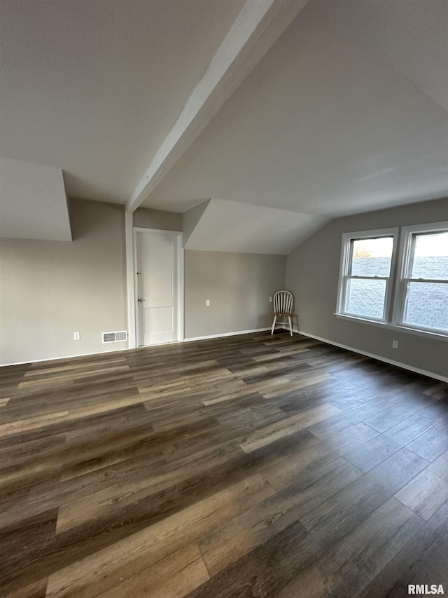 additional living space with dark hardwood / wood-style flooring and lofted ceiling