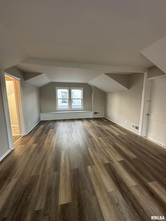 bonus room featuring dark hardwood / wood-style flooring and vaulted ceiling