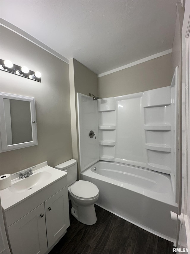 full bathroom with shower / bathing tub combination, vanity, hardwood / wood-style flooring, and toilet