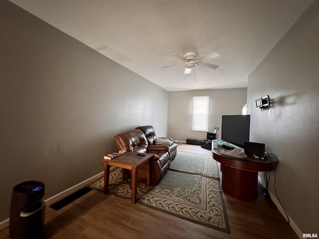 living room featuring wood-type flooring and ceiling fan