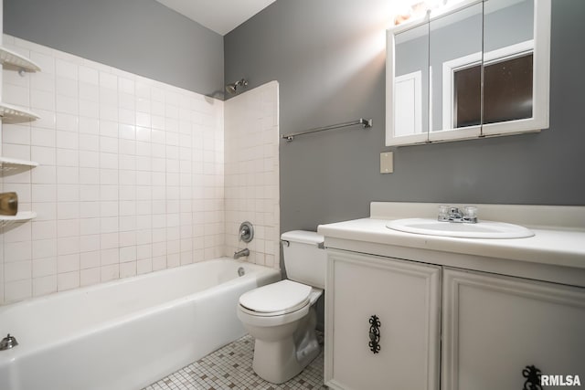 full bathroom featuring tile patterned flooring, vanity, tiled shower / bath combo, and toilet