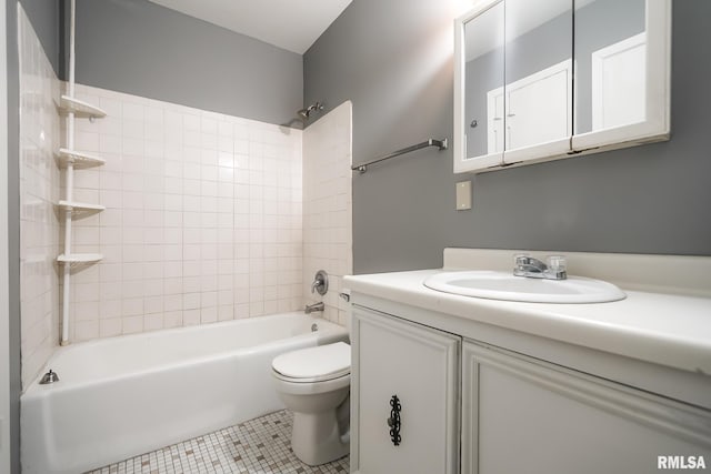 full bathroom featuring tiled shower / bath, tile patterned floors, toilet, and vanity