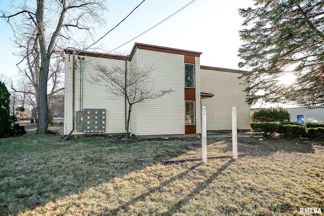 view of side of home with a yard