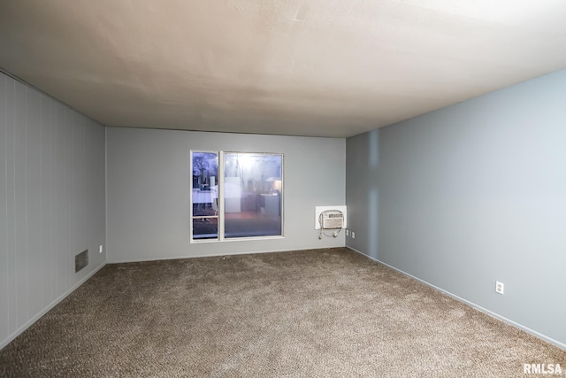 carpeted spare room with an AC wall unit