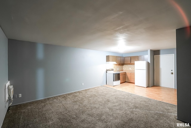 unfurnished living room featuring light carpet