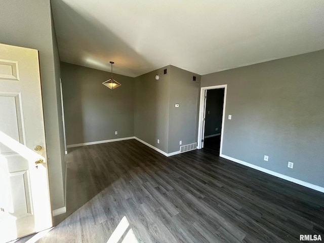 spare room featuring dark hardwood / wood-style floors