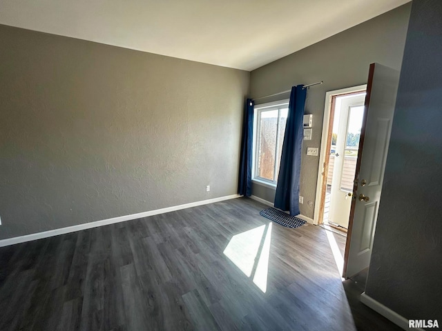 unfurnished room with dark hardwood / wood-style flooring