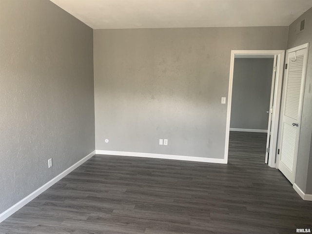 spare room with dark hardwood / wood-style flooring