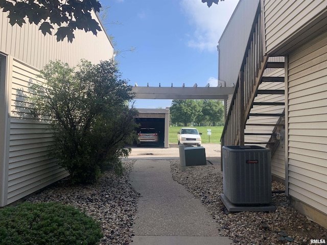 exterior space featuring central AC unit and a carport