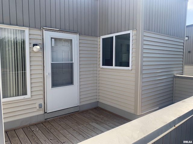 view of exterior entry featuring a wooden deck